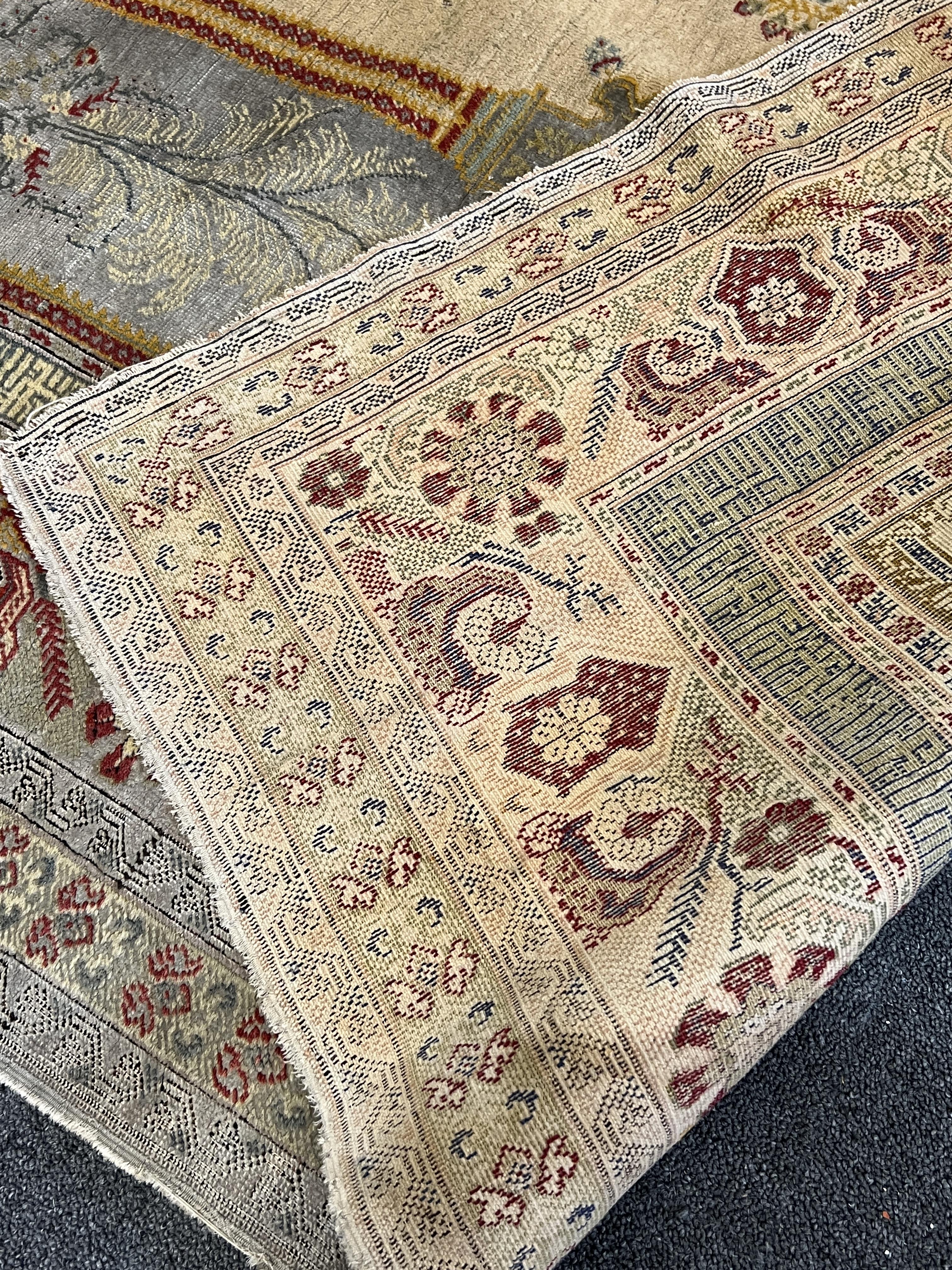 A Turkish silk prayer rug, with central mihrab and stylised floral borders, 205 x 122cm. Condition - worn and faded throughout, all edges worn with a degree of losses.